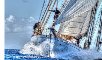 Crew member standing at the box of a sailing yacht