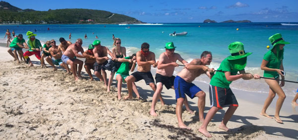 Photograph of people playing tug of war on a beach in St Barths.